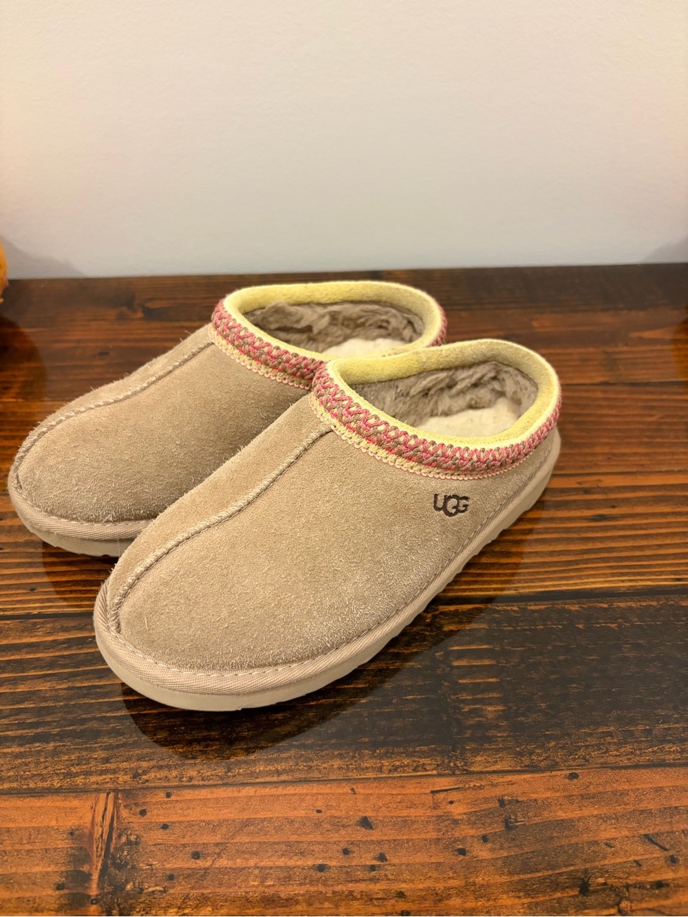 UGG Kids Slip-On Suede Slippers in Tan with Pink Trim